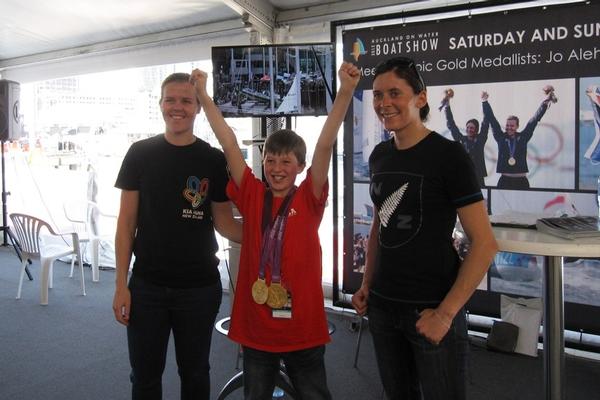 Olympic gold medal-winning 470 sailors Olivia Powrie and Jo Aleh with a young fan at the Auckland On Water Boat Show.